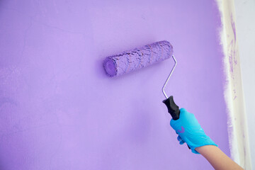 Brush the variegated color paint onto the weathered wooden plank wall 
