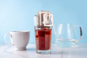 Modern quick instant freshly brewed cup of coffee, Drip brewed bag fresh coffee espresso in glass...