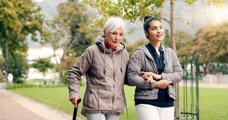 Senior woman, walker and nurse talking in a park with healthcare for elderly exercise. Walking,...