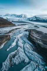 Drone photo of a glacier melting into a river, showcasing climate change