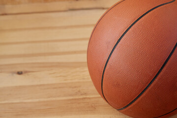 Basketball ball close-up on wooden parquet background. Sports background