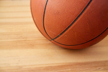A basketball ball close-up on a wooden floor
