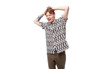 a young 25 year old European man with golden hair is wearing a stylish shirt with a pattern