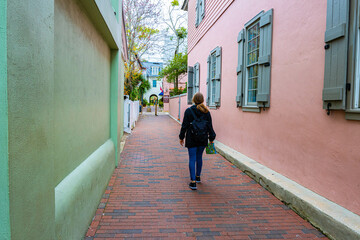 Female Tourists Walking Along Early Colonial Houses and Brick Road in Old Town, Old Town St. Augustine, Florida, USA