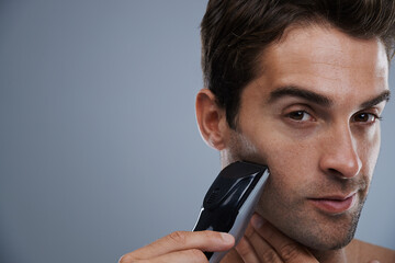 Man, portrait and electric razor for shaving beard or maintenance, hair removal or grey background....