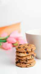 Chocolate chip cookies and a glass of milk coffee on a white background