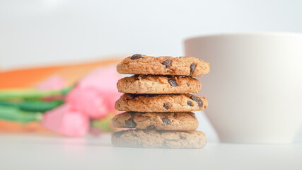 Chocolate chip cookies and a glass of milk coffee on a white background