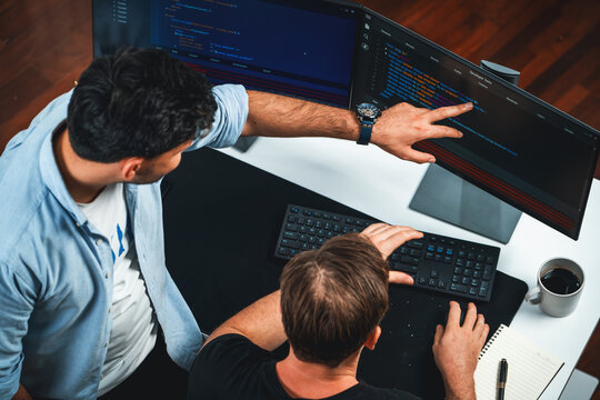 IT developers discussing online software development information on pc screen, creating program coding for latest version application on website. Concept of brainstorming firmware updated. Sellable.