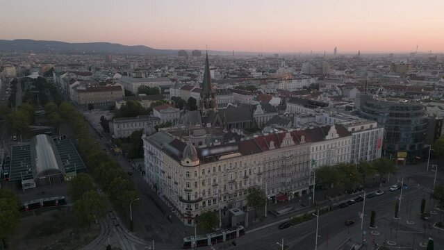 Vienna city sklyine aerial view drone footage fly over vienna asutria downtown in front chruch at sunset.