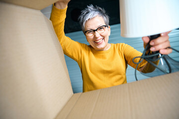 Smiling lady looks into a box of things