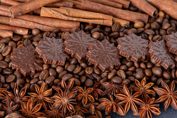 Food background. Coffee beans, cinnamon sticks, anise stars and chocolate candies top view.