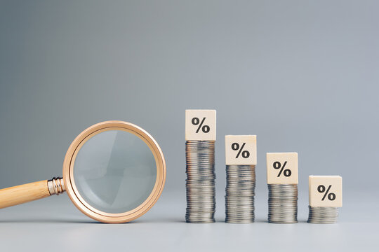 Decreasing money heaps with percentage icon, and magnifying glass, analysis, understanding, of percent, commission sales, debt, business and finance