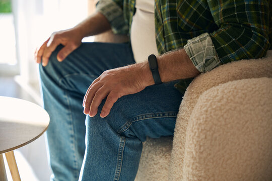Man in casual clothes is in a cozy bright room