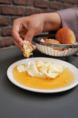 butter cream and honey in a bowl on table .
