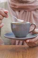 women holding a coffee cup 