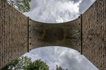 Dardilly, France - 08 05 2023: View of a railway bridge from the bottom of the forest.