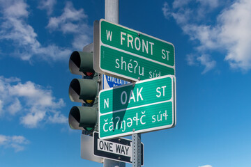Low angle view of bilingual (English and Klallam) street signs on the Port Angeles, WA, USA waterfront as a way to honor the Lower Elwha Klallam Tribe, whose traditional land this is