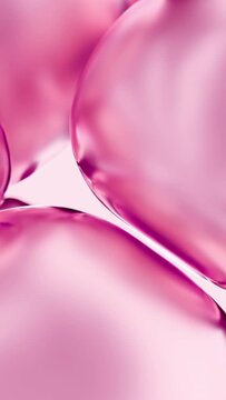 Liquid pink rose oil bubbles macro close up. Abstract cosmetic 3D animation background of fluid circles. Beauty care concept of decorative antioxidant peptide soap spheres in light water background.