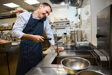Kitchen worker communicates on a mobile phone