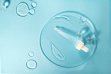 Drug development. Skin care cosmetics. Medical pipette on a blue background. The liquid essence...