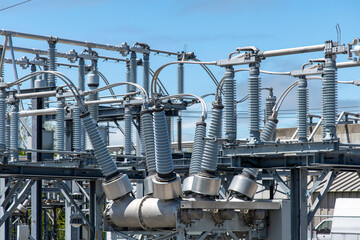Close up view of some high-voltage bushings on a utility transformer at an electrical substation...