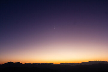 Sunset scenery view with crescent moon and mountain landscape in winter season, Chiang Mai, Thailand