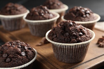 Delicious chocolate muffins on table, closeup view