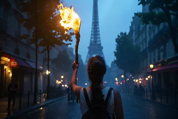 Zelfklevend Fotobehang Mysterious Figure Holding a Flaming Torch Near the Eiffel Tower © Virginie Verglas
