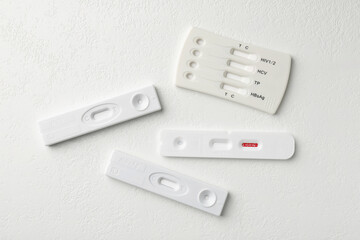 Different disposable express tests on white table, flat lay