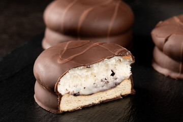 Delicious chocolate marshmallow on dark background, low key photography