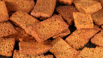 Close-up of fresh bread slices with paprika on a dark background