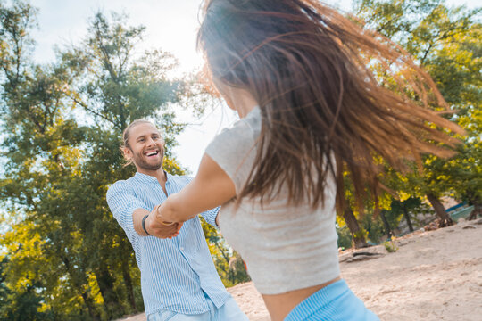 Happy couple dancing together on their trip. Caucasian man and woman enjoying at the beach, spending time, having fun. Holidays and honeymoon concept