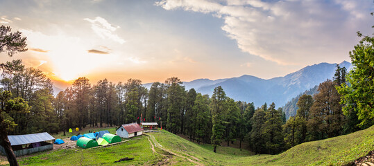 Panoramic view from Gharoli Patal of Roopkund and Ali Bedni bugyal trek base campsite. Trek is full of diversity from majestic Himalayan ranges to lush green meadows and deep virgin forests.