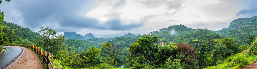 Panoramic view of Pachmarhi valley having clouds and mist shrouded hills rolling on each other from Chaudeshwar Mahadev Temple road in Pachmarchi, Madhya Pradesh, India.