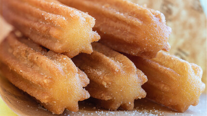 Churros con azucar. Close up view of delicious traditional Spanish sugar churros freshly made to...