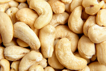 Cashew nut heap food texture background, macro shot. A wholesome nut snack