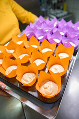 Experienced baker preparing to bake batch of muffins