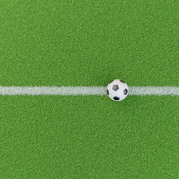 Chalk line on a groomed grass field with a soccer ball. Base image for composites for soccer sports images. High angle view.