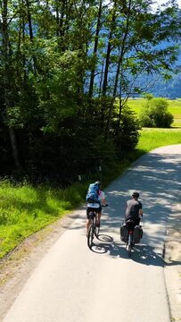 Two Cyclists Riding Through the Allgäu Region in Bavaria, Germany