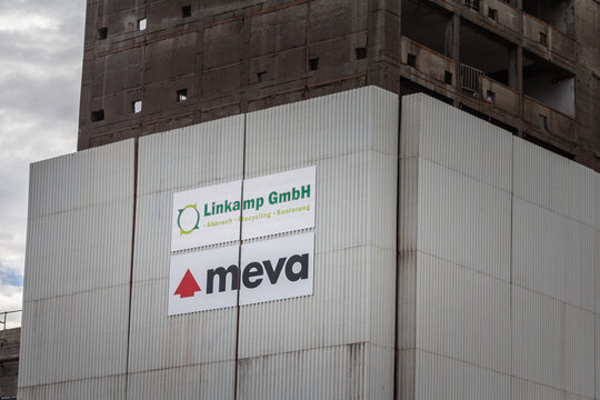 Picture of a sign with the logo of Meva on their depollution formwork structure on a building of cologne, Germany.