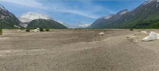Gravel valley floor near north fork Crescent River and Mount Redoubt Volcano at Lake Clark National...
