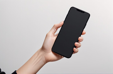 Fototapeta na wymiar Woman hand holding the black smartphone with blank screen and modern frameless design two positions angled and vertical - isolated on white background