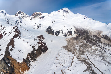 View of southeast flank of Iliamna Volcano showing debris avalanche deposits from 1997, fumarole zone near summit, and older avalanche scar at head of Red Glacier. Lake Clark National Park, Alaska.