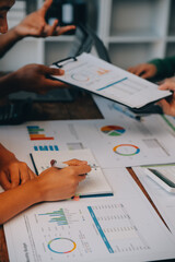 Male mature caucasian ceo businessman leader with diverse coworkers team, executive managers group at meeting. Multicultural professional businesspeople working together on research plan in boardroom.