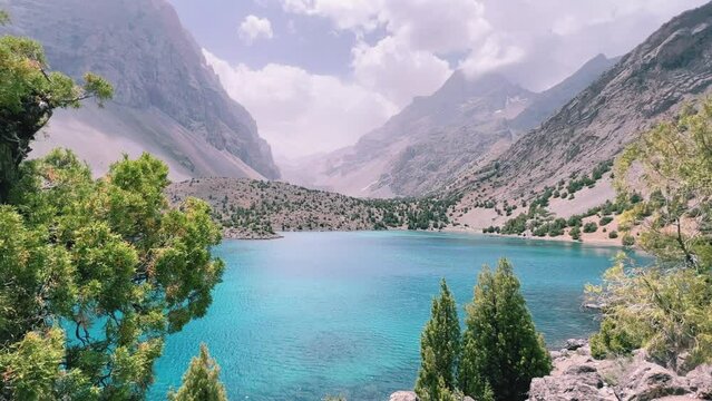 The Alaudin (Chapdara) lakes, lying at an altitude of 2800 m, are considered one of the most beautiful lakes of the Fan Mountains. Turquoise mountain lake. Pamiro-Alai. Tajikistan, Pamir 4K