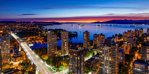 Downtown Vancouver Cityscape on West Coast of Pacific Ocean. Night after Sunset. Aerial Panorama