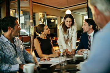 Diverse business people talking in cafe or bar