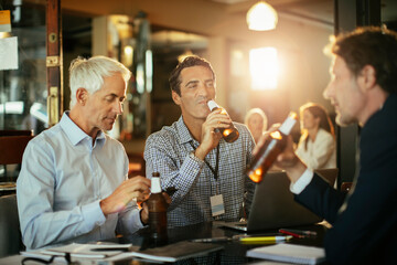 Businessmen drinking after work at a bar
