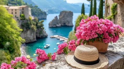 Gardinen Summer Scene with Pink Bougainvillea and Straw Hat Overlooking Coastal Italian Landscape © nnattalli