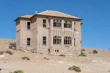 forsaken former "Quartermeister" building on sand at mining ghost town in desert, Kolmanskop,  Namibia